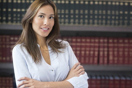 paralegal standing in front of book case