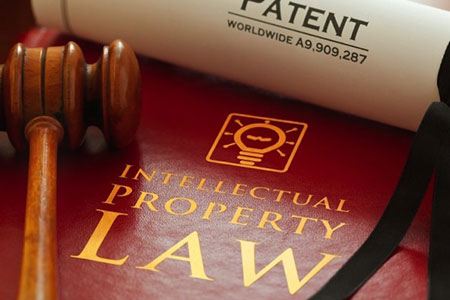 closeup of intellectual property law patent and gavel