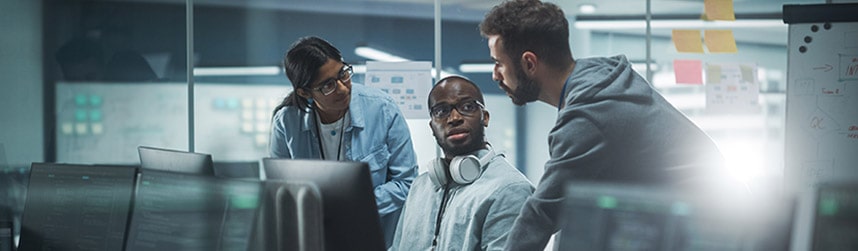 three computer engineers discuss issue on screens