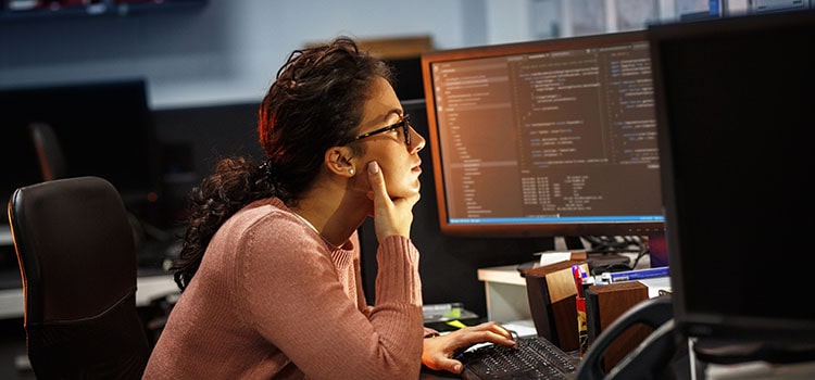 developer looks at computer screens of code