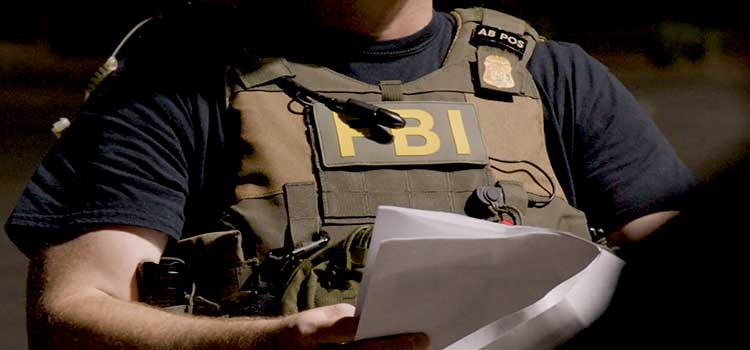 vested fbi agent with paperwork orders
