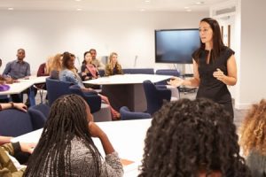 speaker presenting to classroom of adult learners