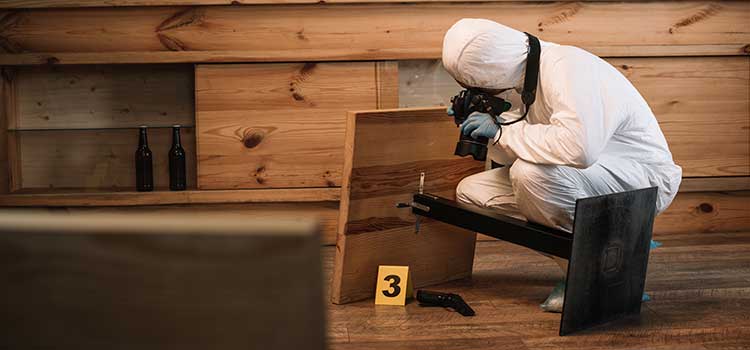 forensic specialist photographing crime scene