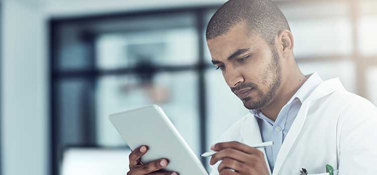 man looking at tablet for hacks