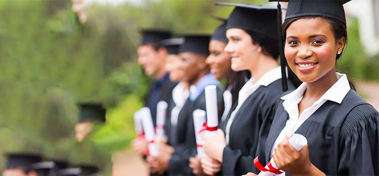 line of bachelor's degree college graduatres in mortarboards holding diplomas