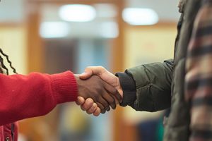 two men shaking hands in reconciliation
