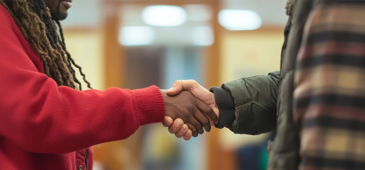 Two men shaking hands in reconciliation